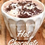 A small cup of hot cocoa topped with chocolate shavings