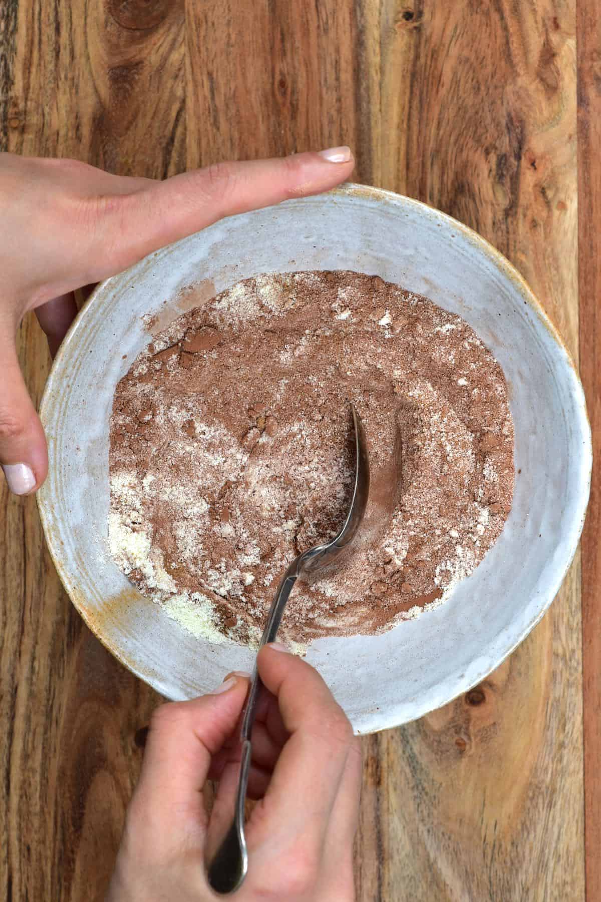 Mixing ingredients for hot chocolate mix in a bowl