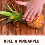 Rolling a pineapple on a wooden board