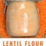 A jar of red lentil flour placed over red lentils