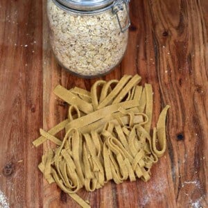 Oat pasta cut as tagliatelle and a jar of oats