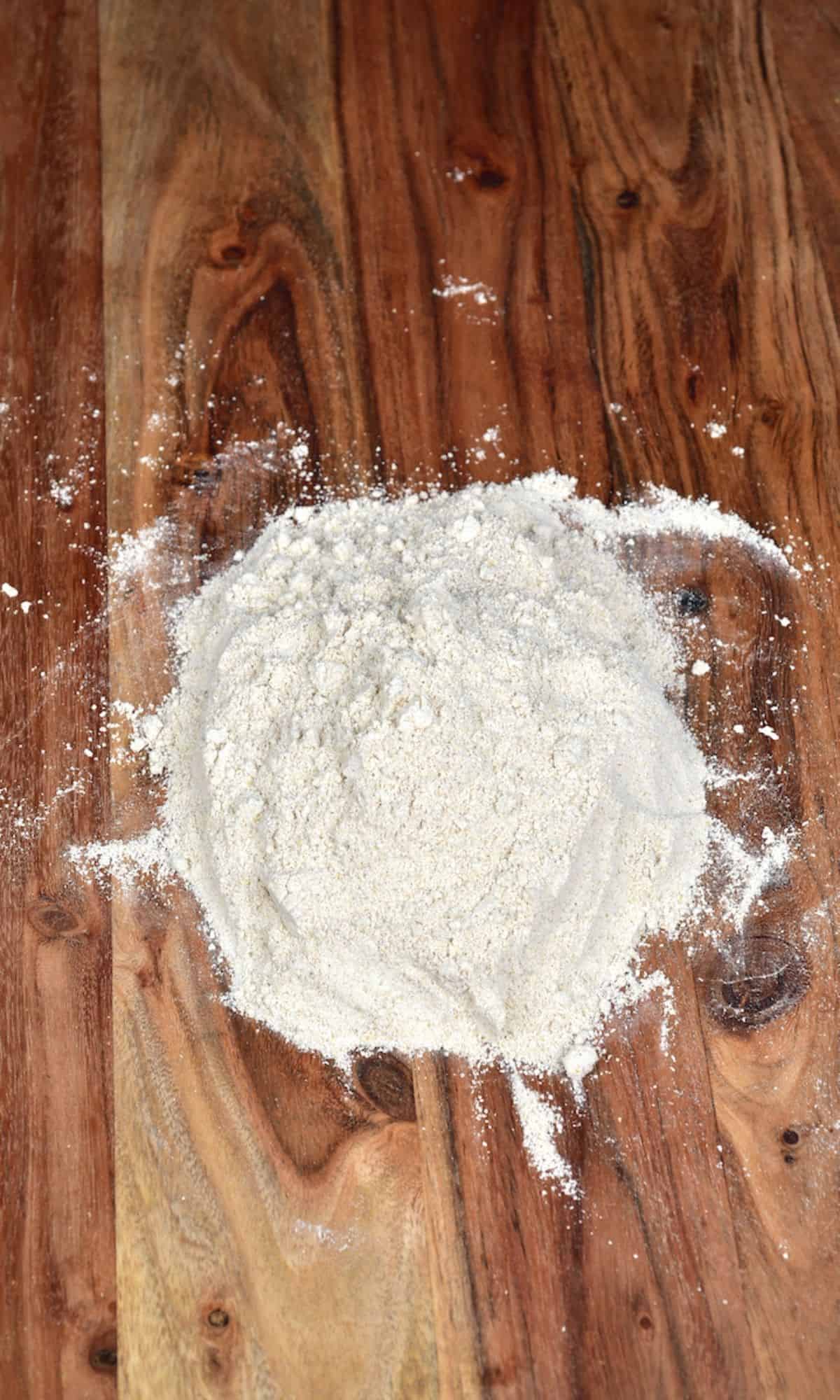 Oat flour on a wooden surface