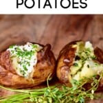 Two salt baked potatoes with cream and herbs toppings