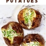 Three salt baked potatoes with cream and herbs toppings