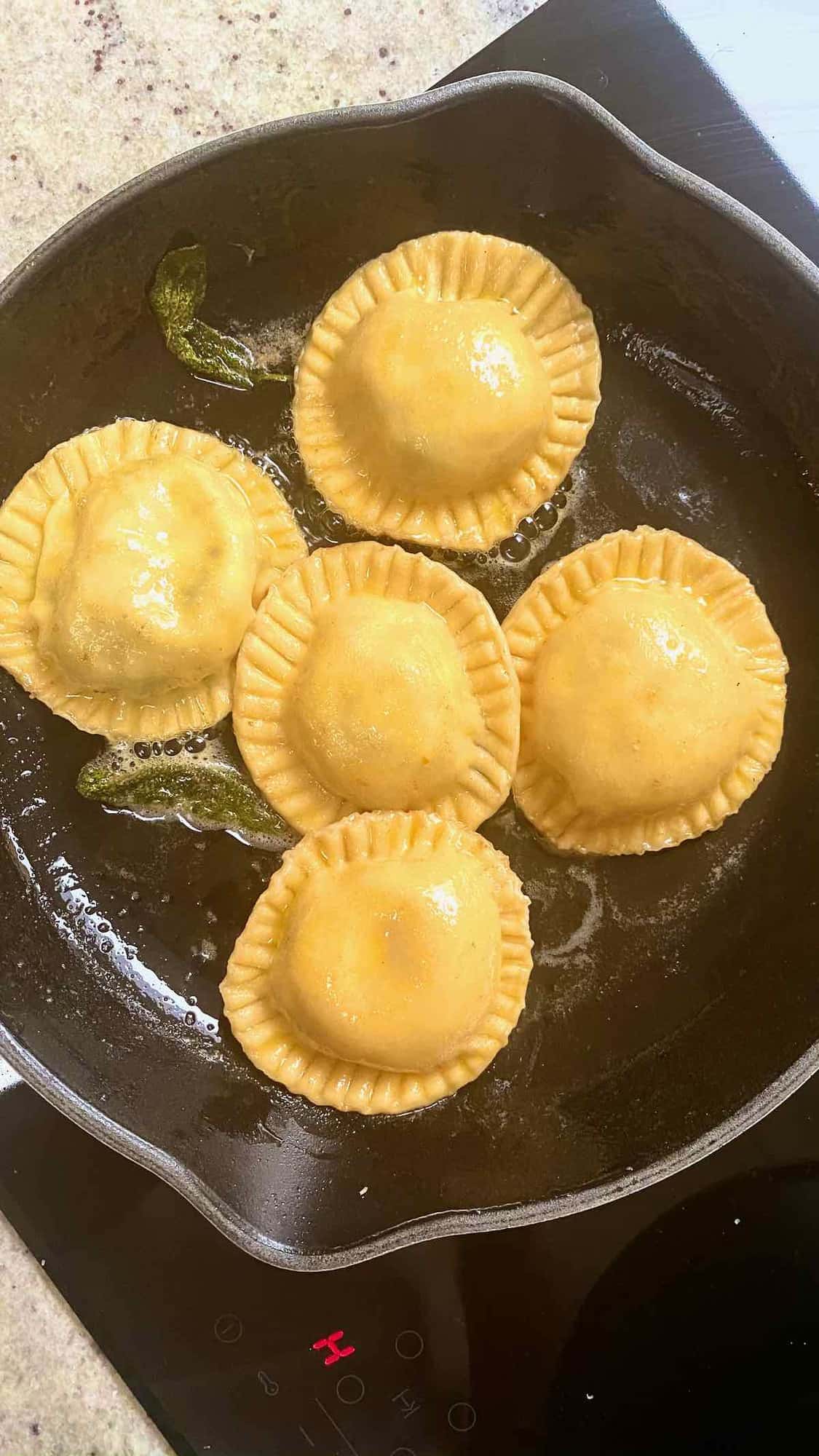 Pan frying ravioli with some butter in a pan