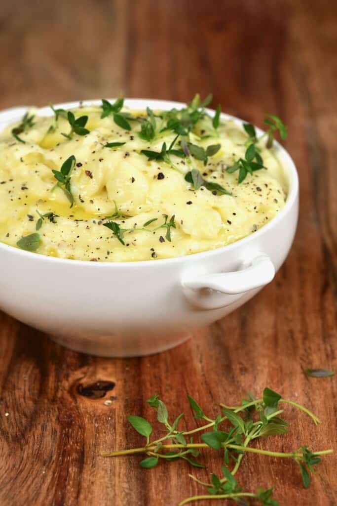 Mashed potatoes topped with thyme and pepper