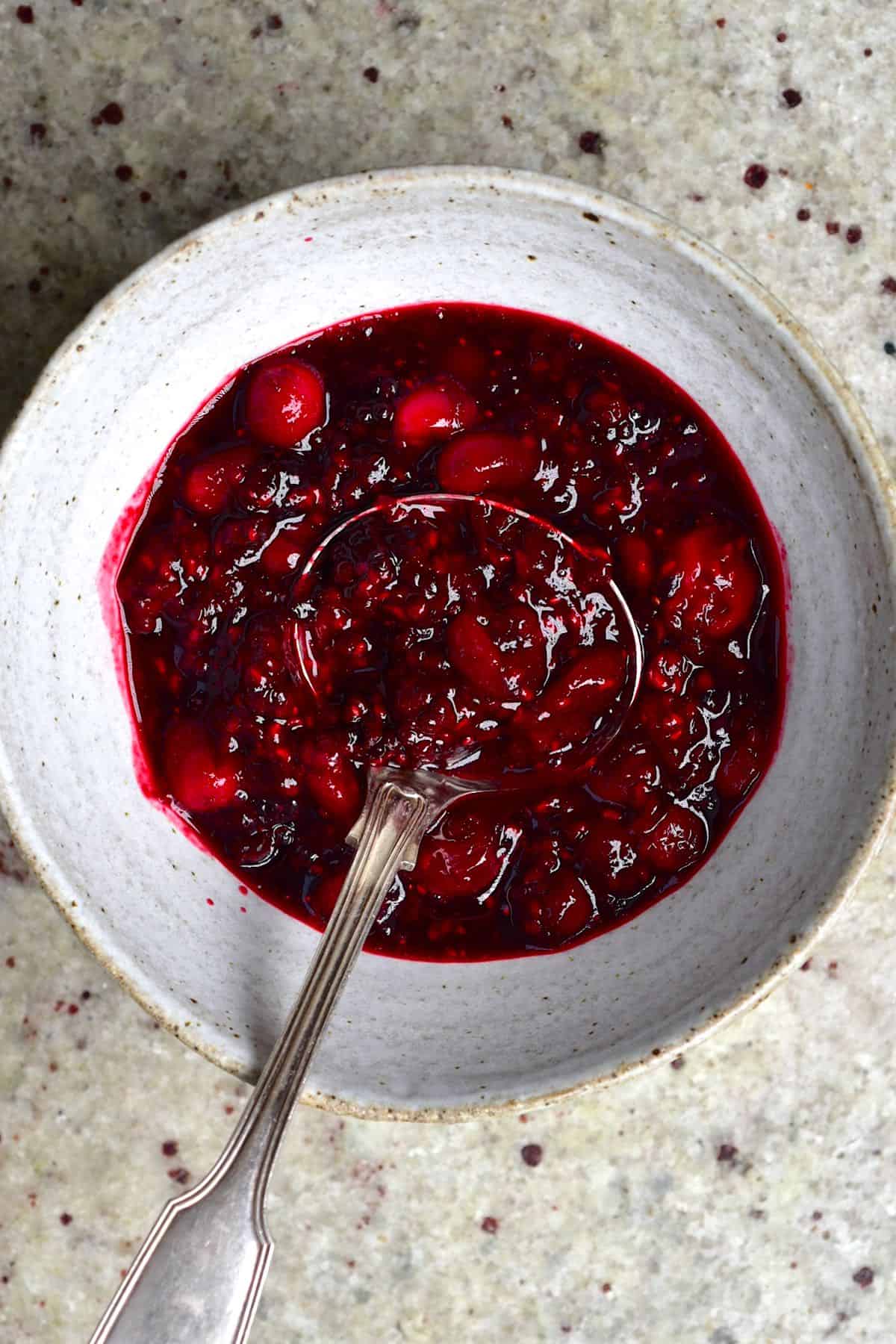 Berry compote in a bowl with a laddle