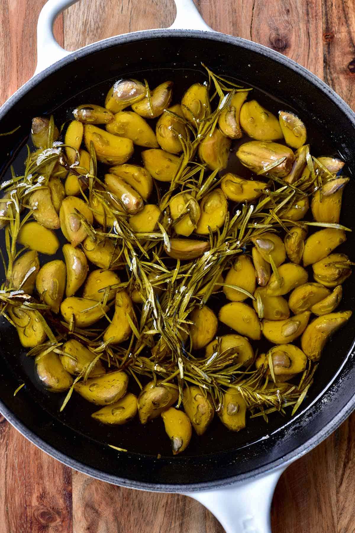 Garlic confit in a pan