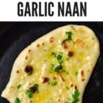A piece of garlic naan in a pan