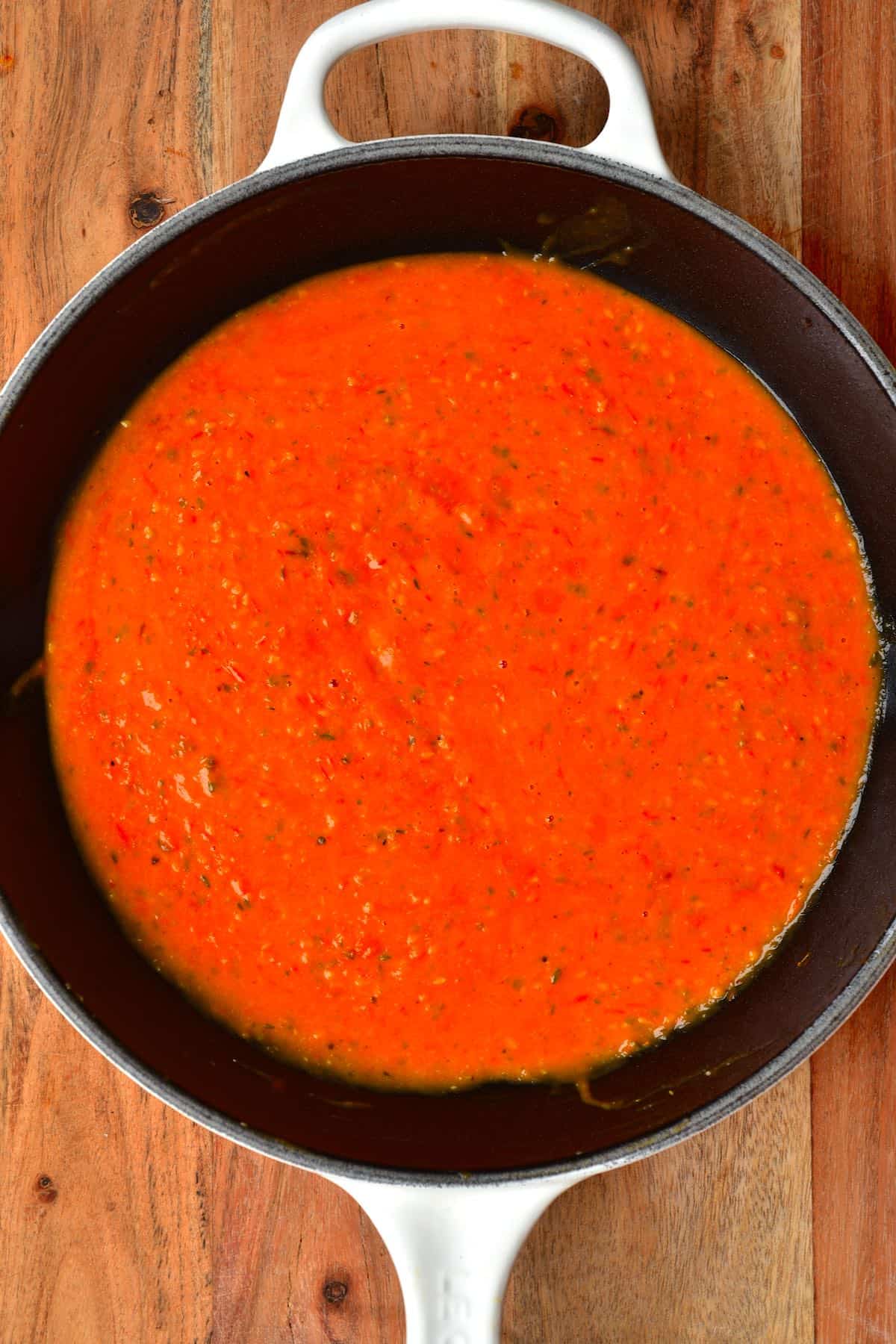 A pan with roasted red tomato sauce