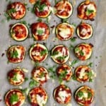 Baked Zucchini pizza bites on parchment paper