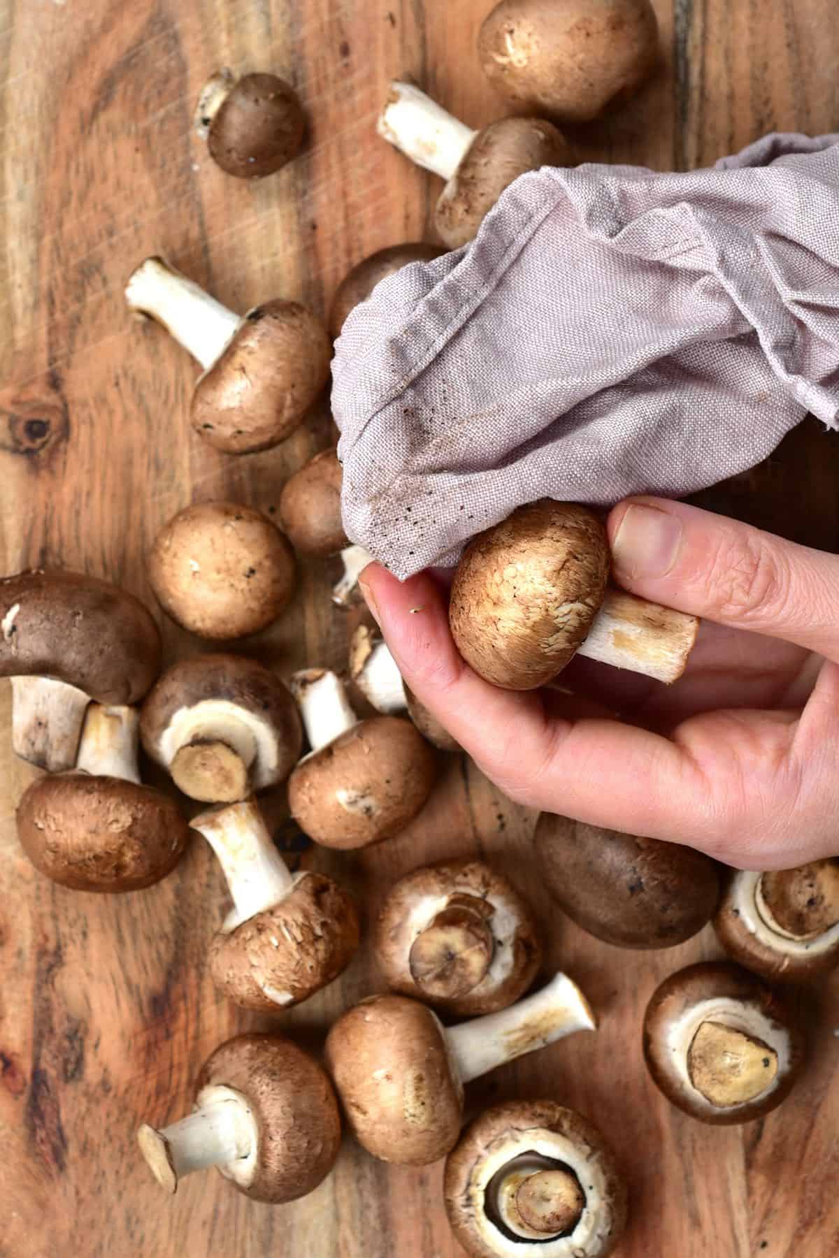 Cleaning mushrooms with a kitchen towel