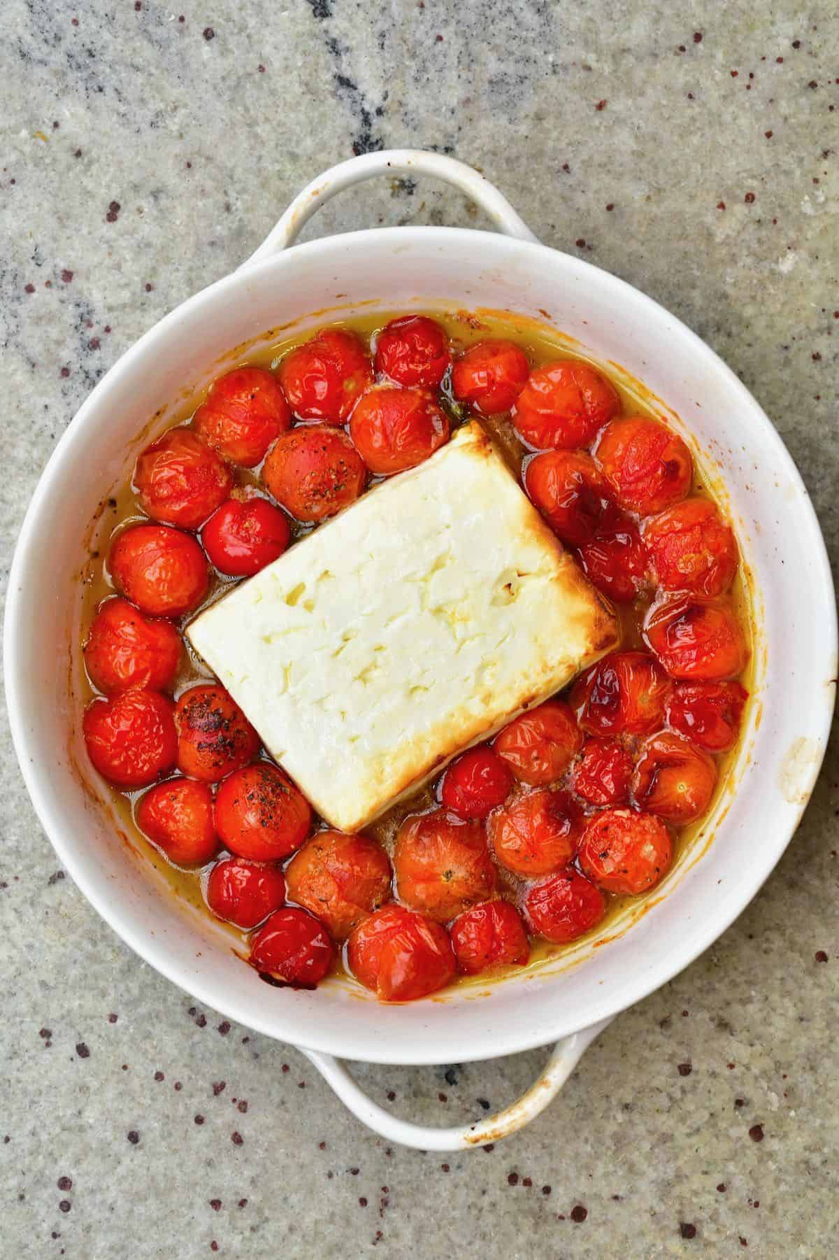 A dish with baked Baked Feta and tomatoes