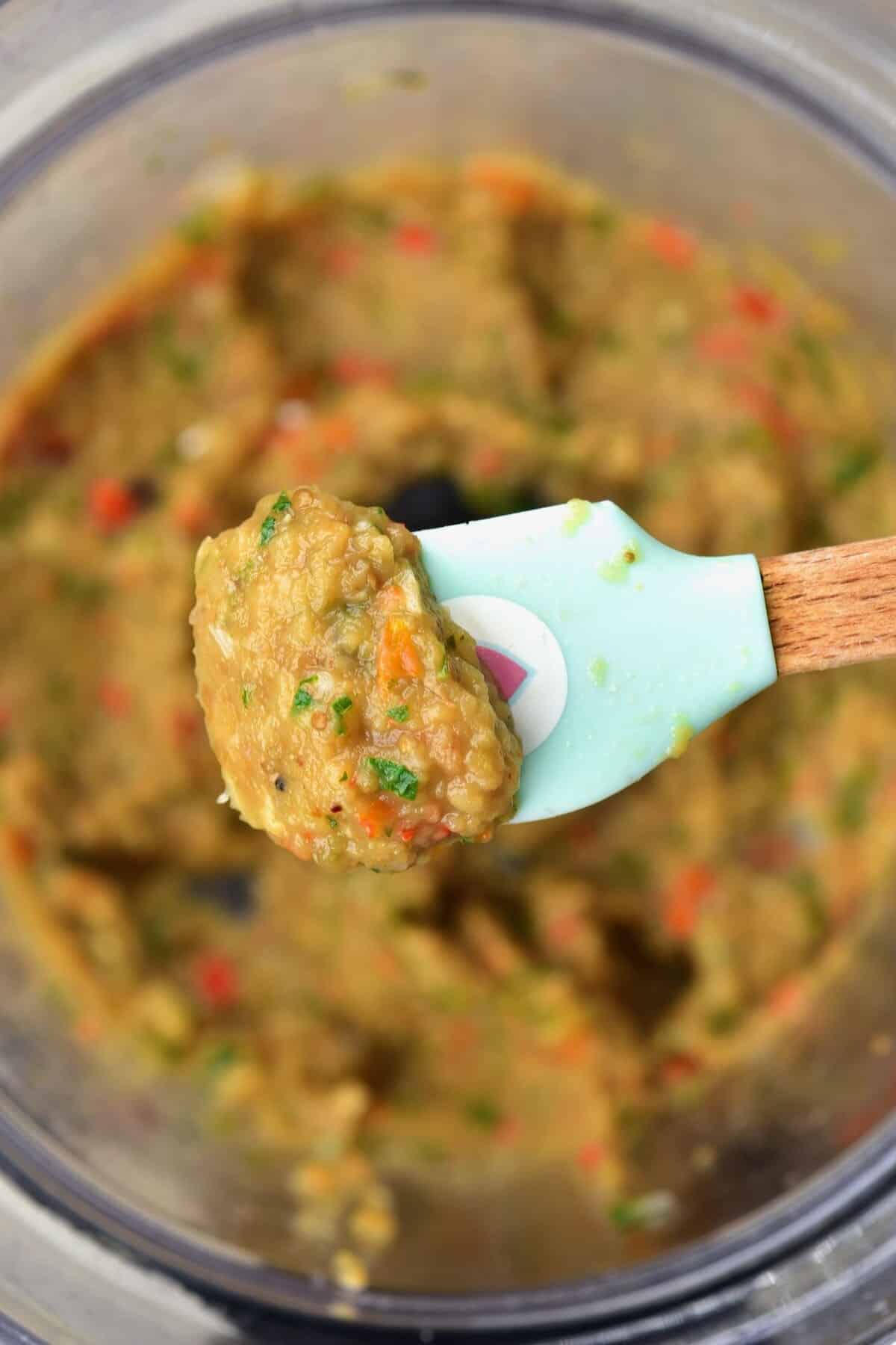 Close up of a spoonful with Caribbean eggplant dip