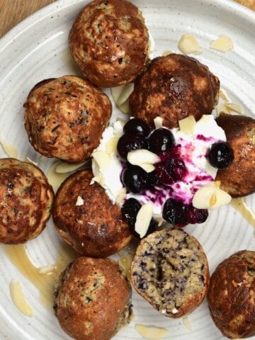 Blueberry Mini Pancake Balls served with yogurt in a plate