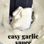 A close up of spoonful of garlic sauce