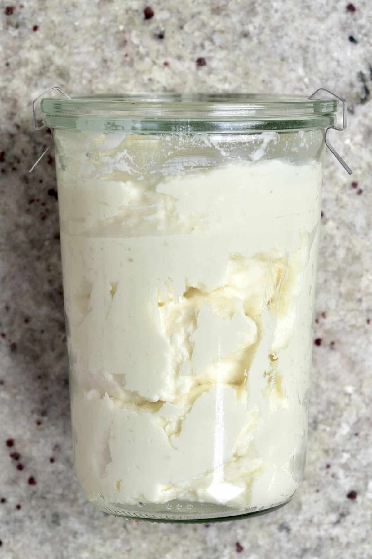 A jar filled with with garlic sauce