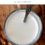 Instant almond milk in a glass with a spoon