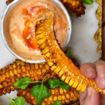 Dipping a spicy corn rib into chili mayo