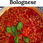 A large pan with Vegan bolognese sauce topped with basil leaves