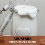 Whipped aquafaba in a large jar