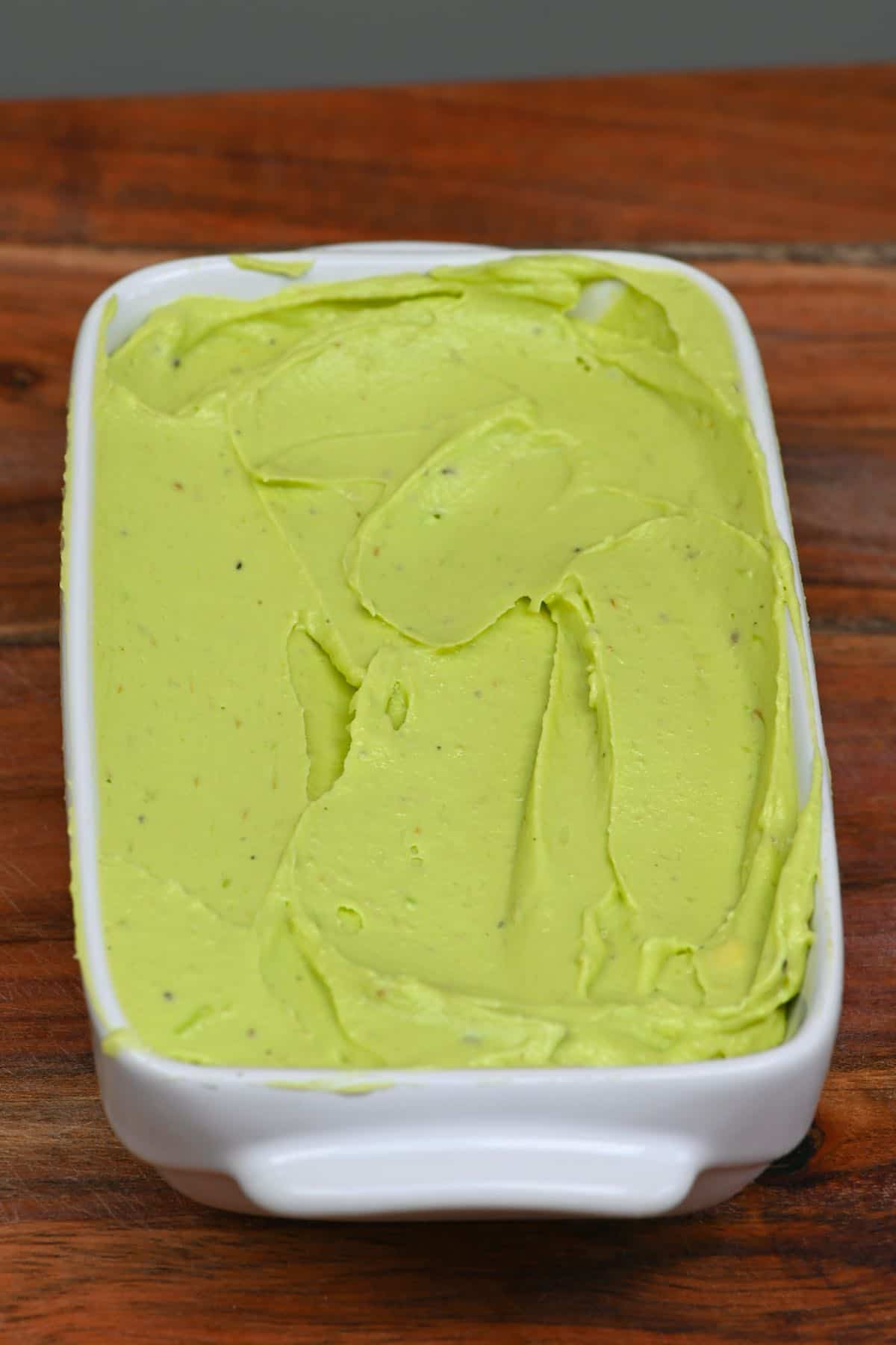 Smoothed avocado butter in a butter dish