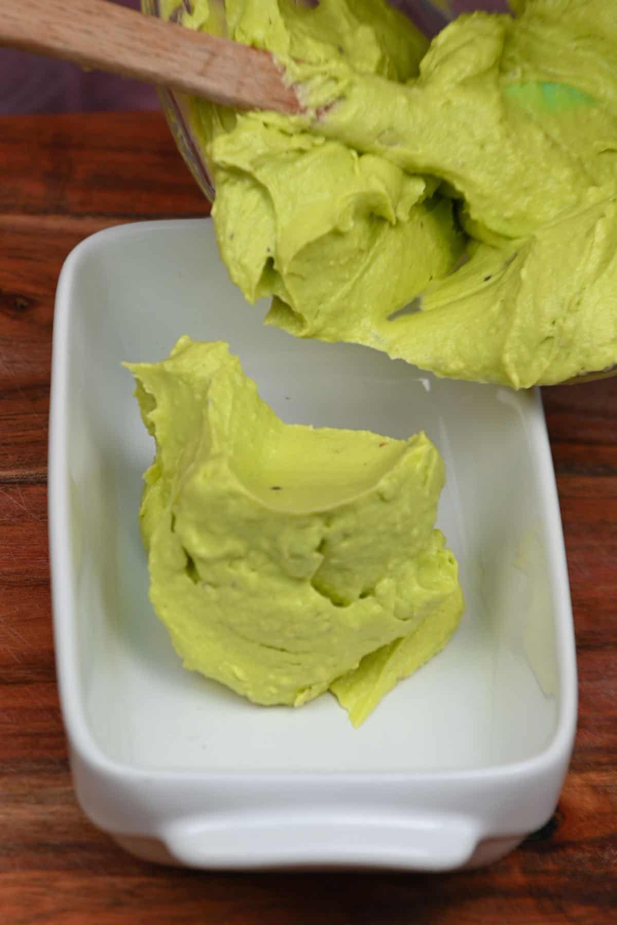 Transferring avocado butter into a container