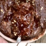A spoonful of chocolate baked oats topped with hazelnuts