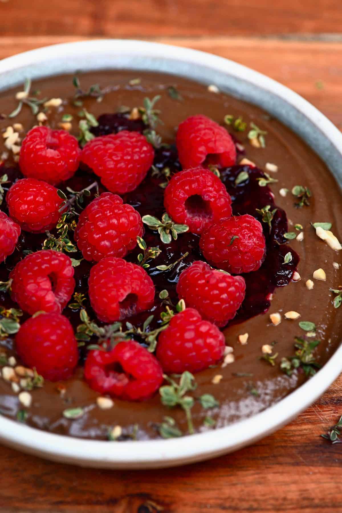 Chocolate hummus topped with raspberries and lemon thyme