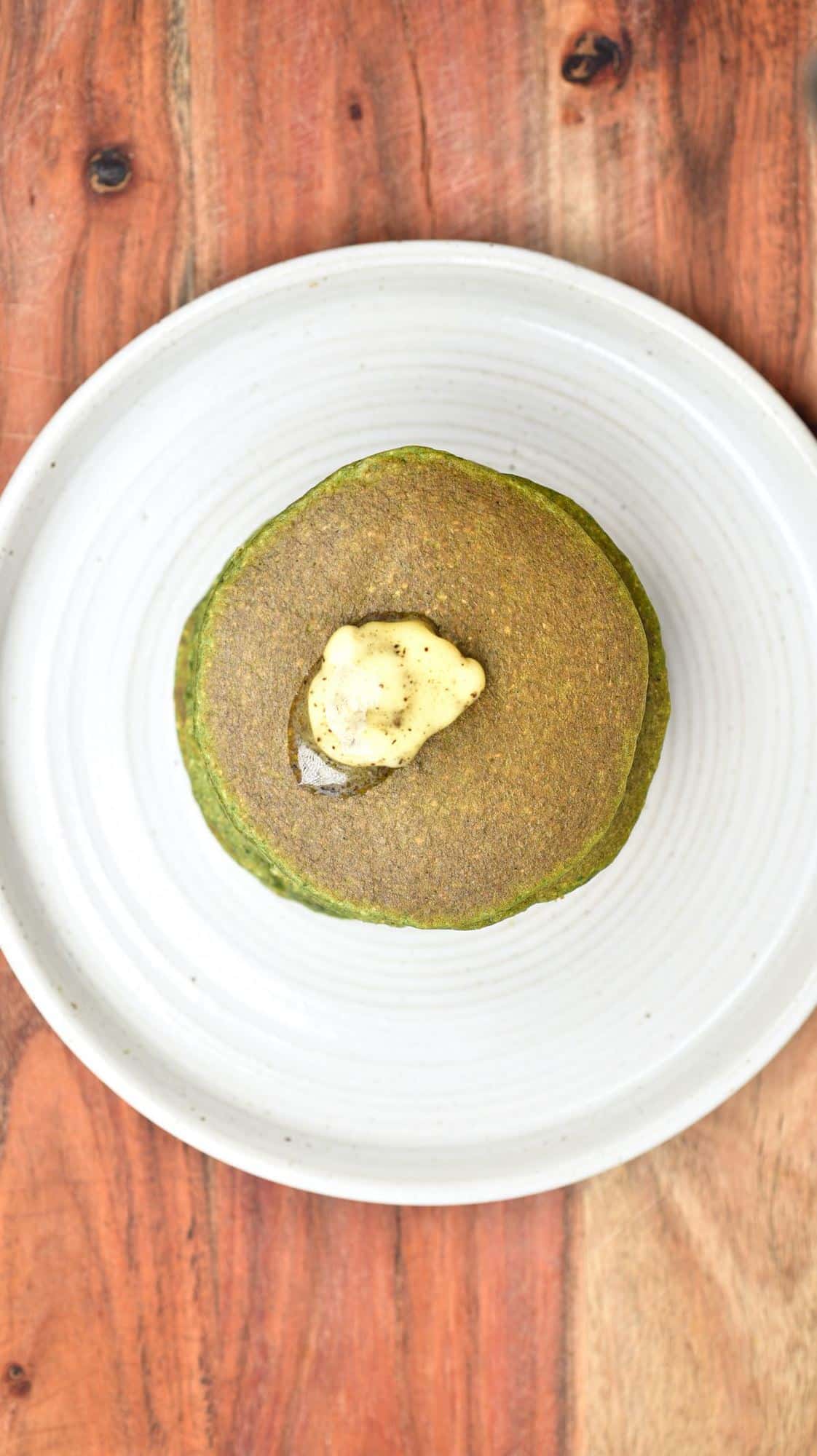 Green pancake with vanilla butter on top