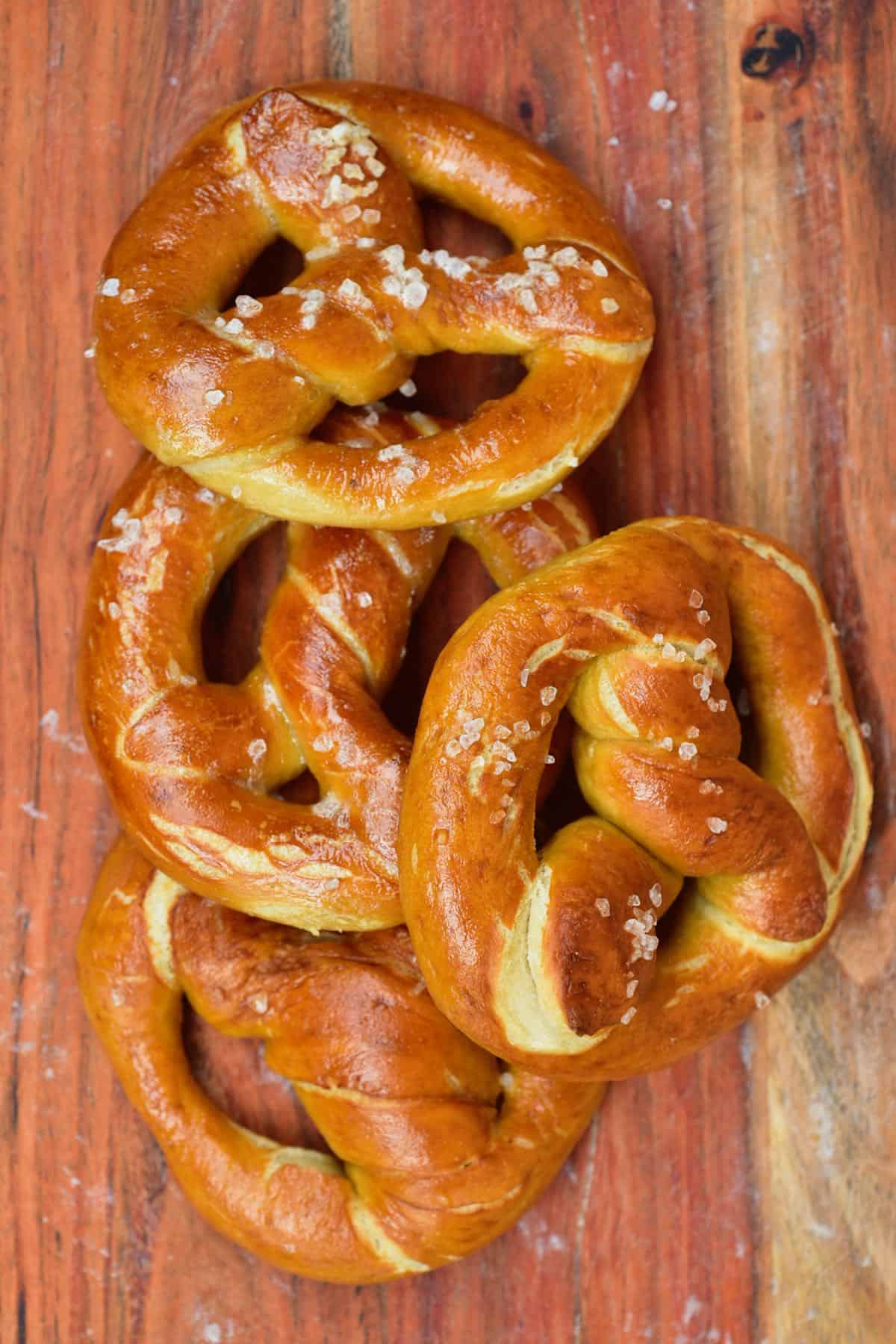 Four pretzels overlapping on a flat wooden surface