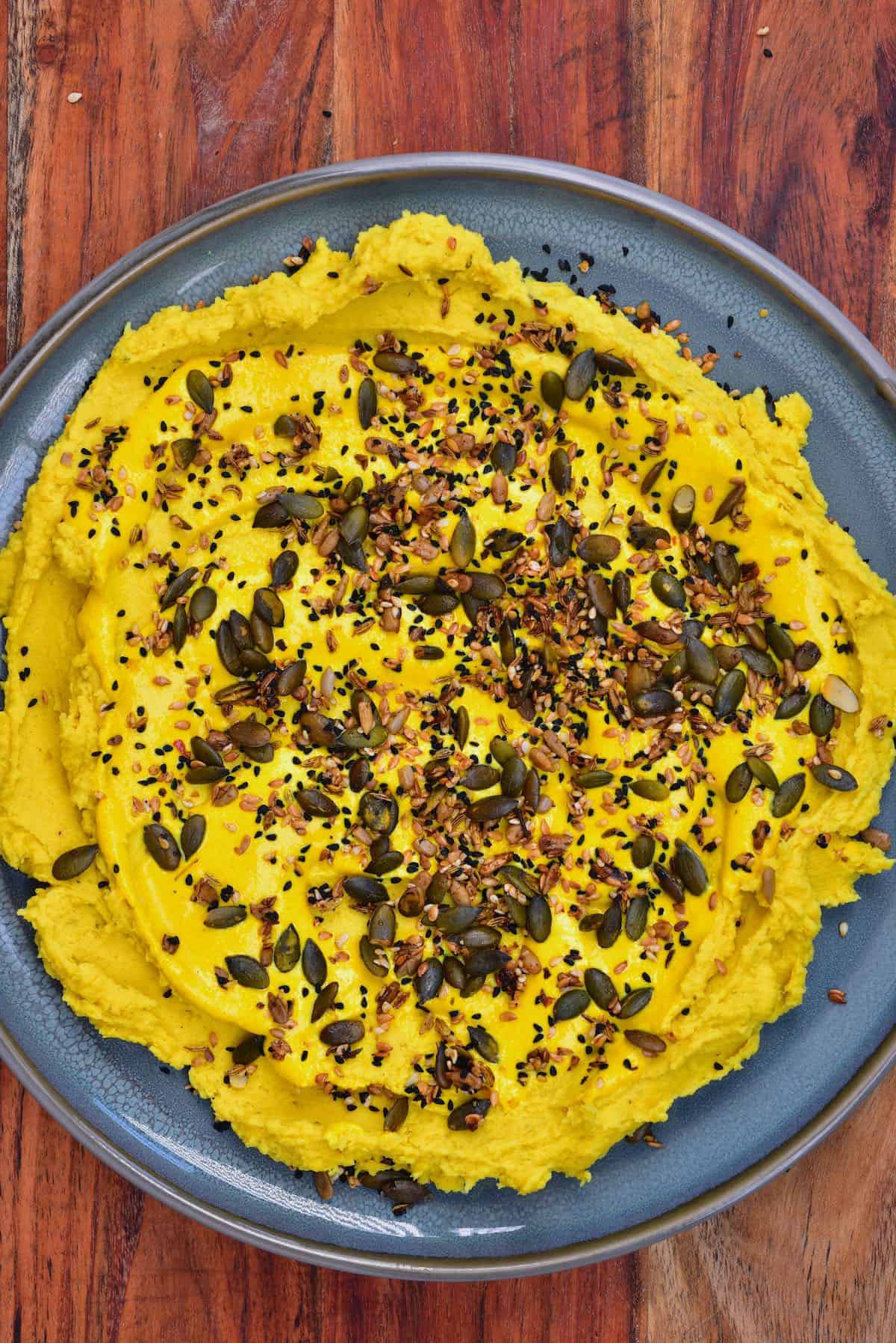 Split pea dip topped with seed mix