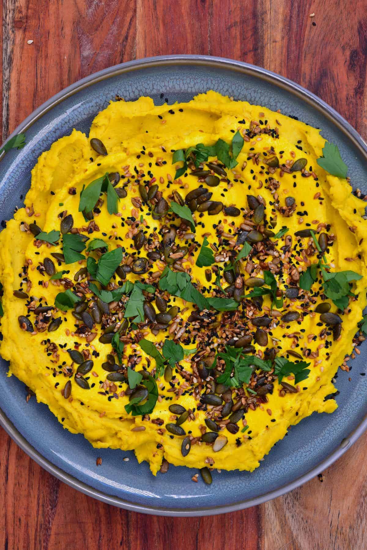 Split pea dip topped with seeds and parsley