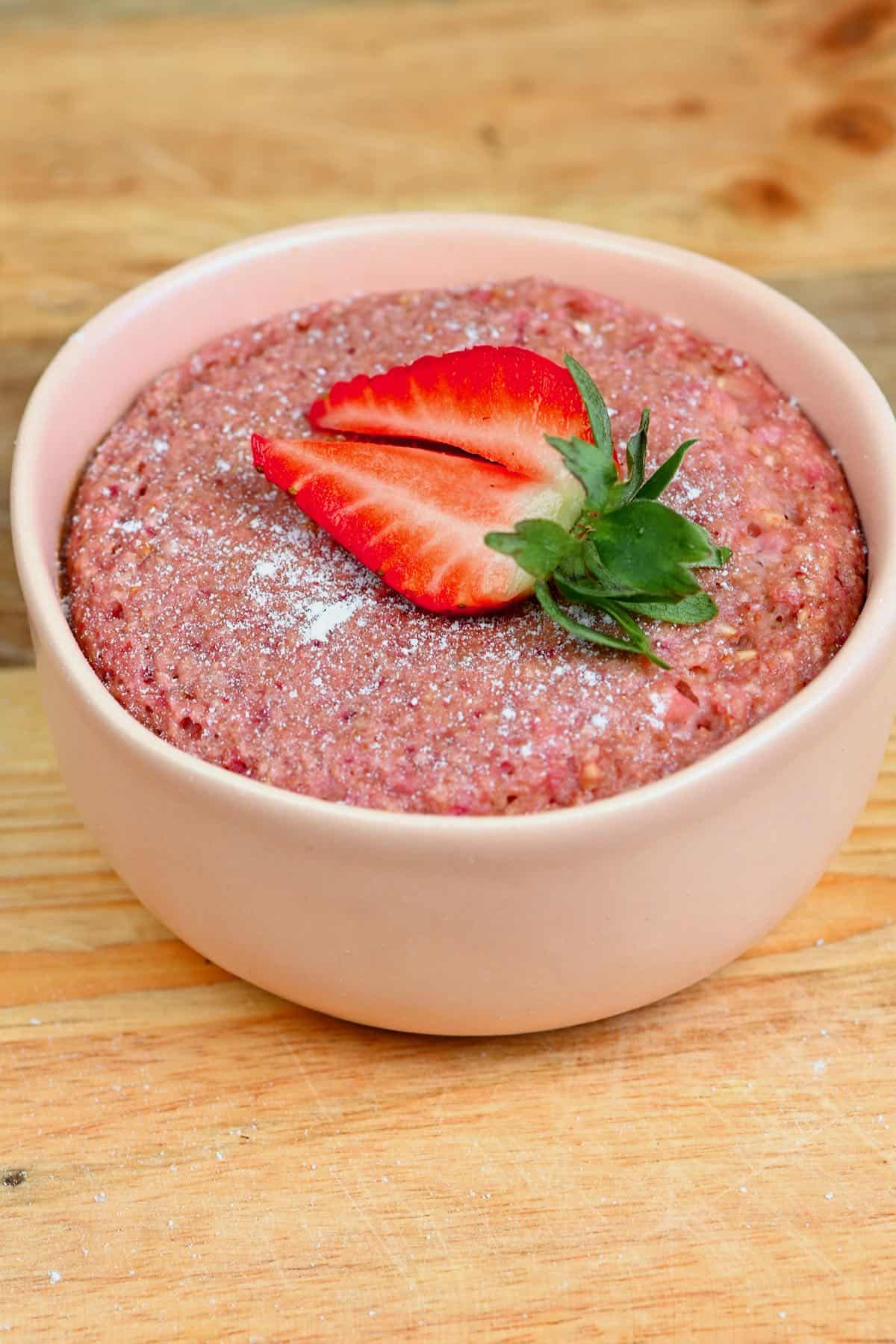 A strawberry on top of strawberry baked oats
