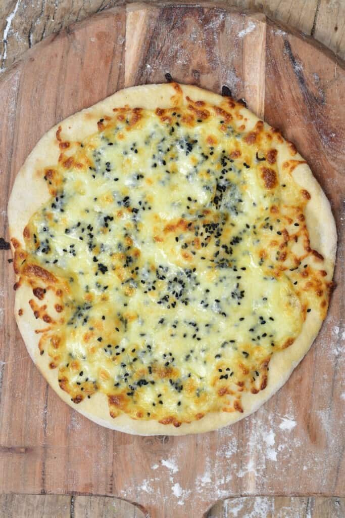 A baked cheese manakish topped with nigella seeds