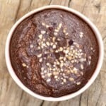 Chocolate baked oats topped with hazelnuts