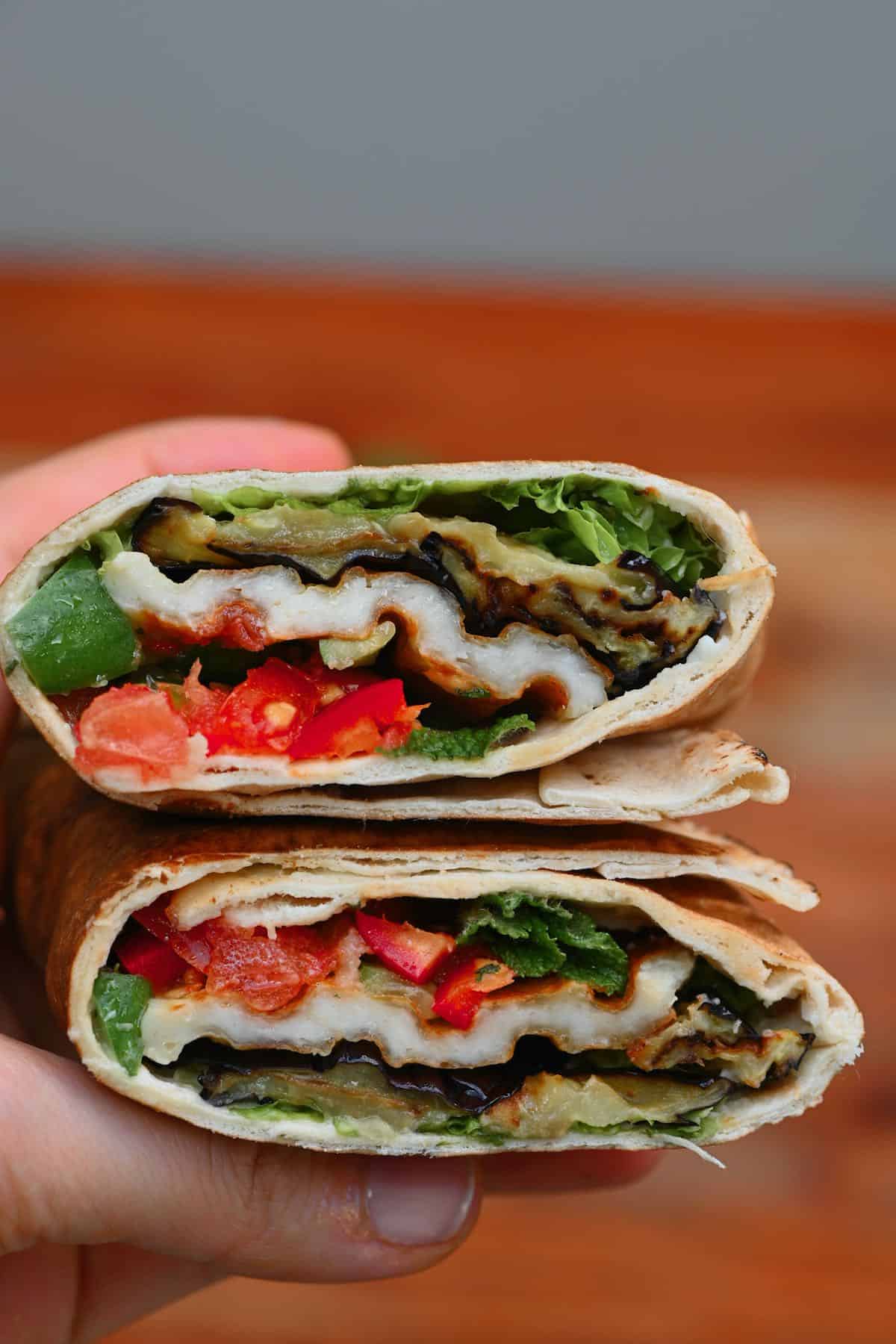 Two halves of an eggplant wrap