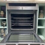 A clean open oven with all of its wracks arranged