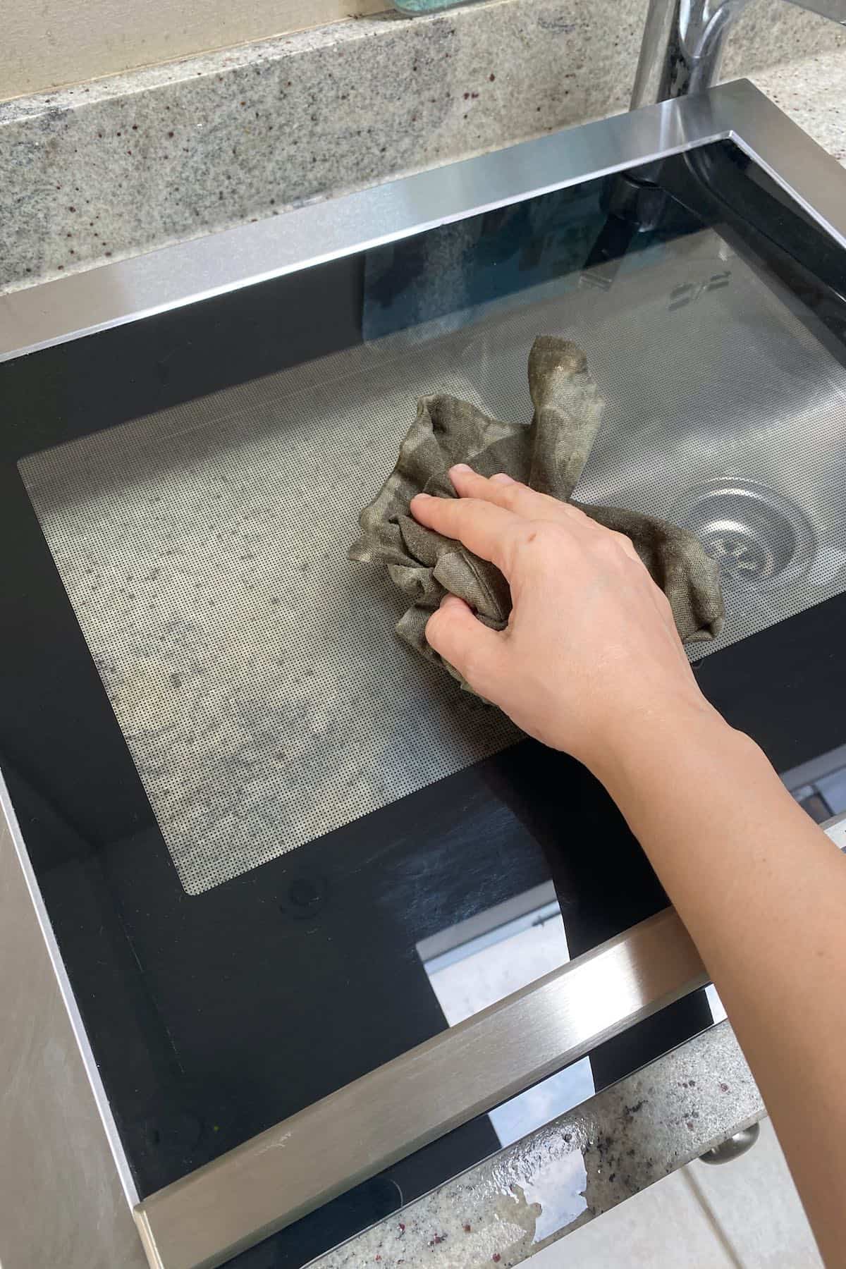 Wiping down an oven door