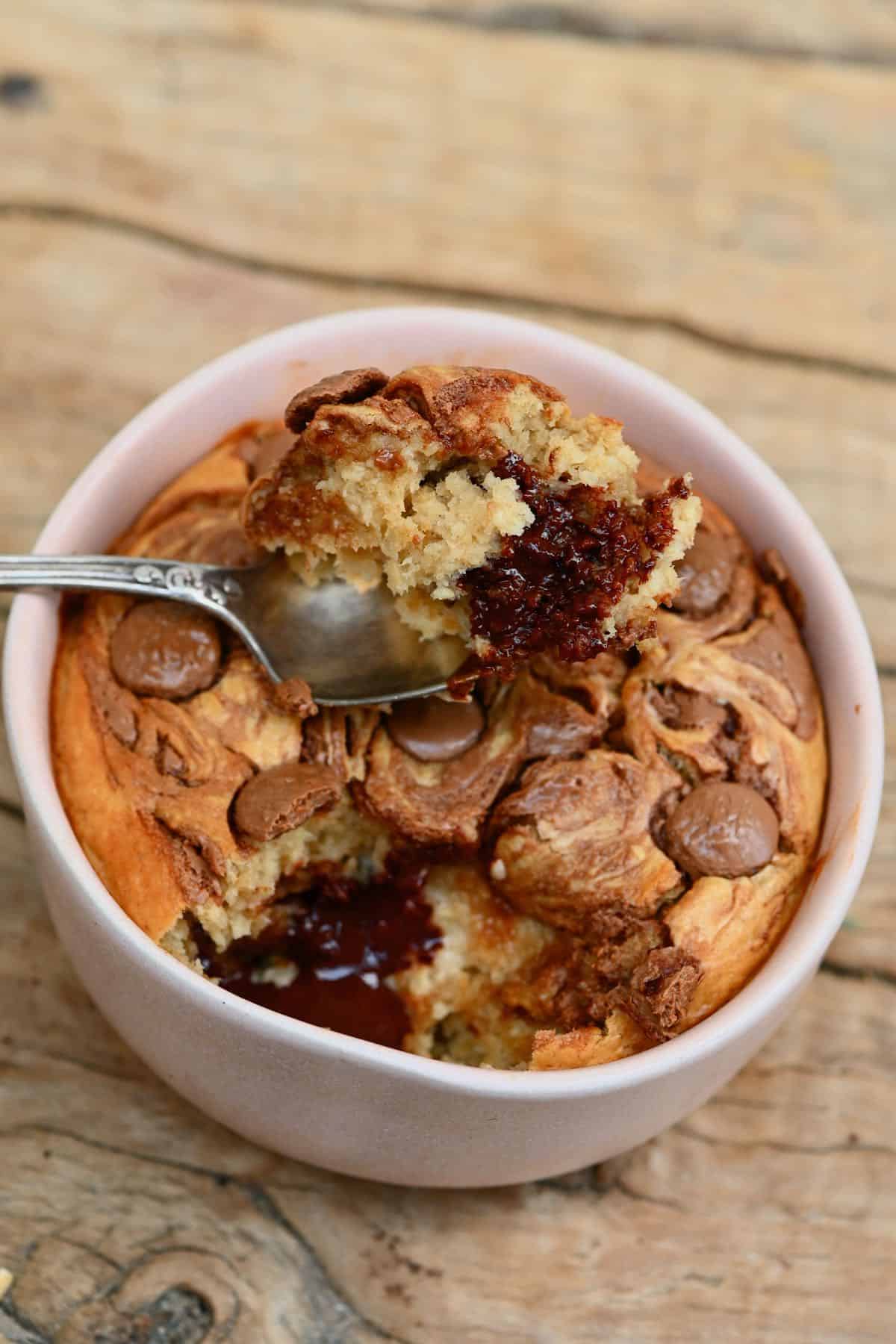 A spoon dipped in peanut butter chocolate baked oats