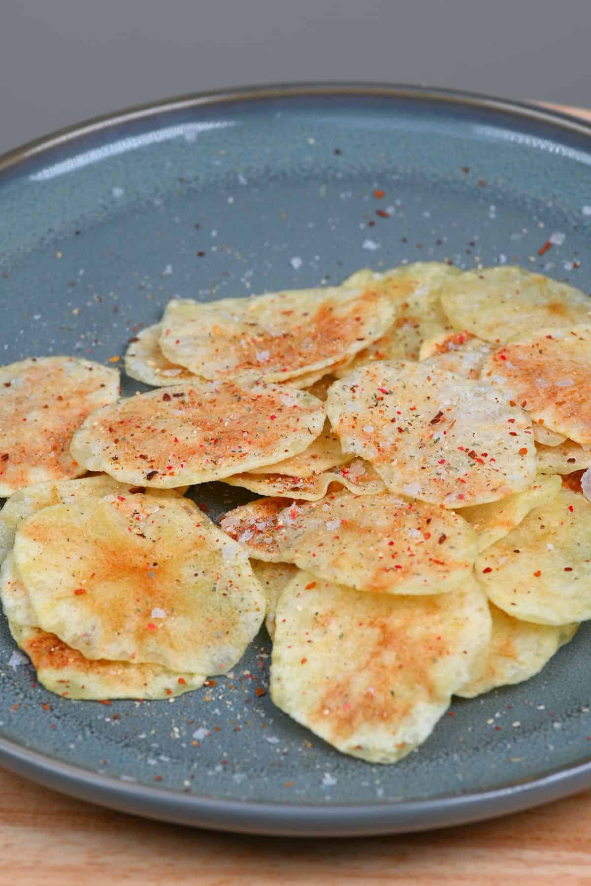 Potato chips with salt and spice in a plate