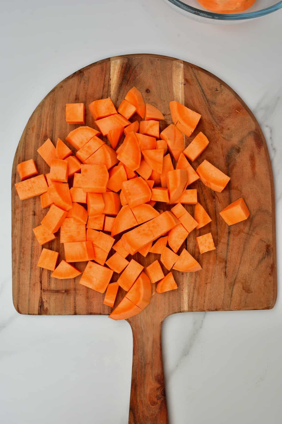 Chopped sweet potato on wooden board