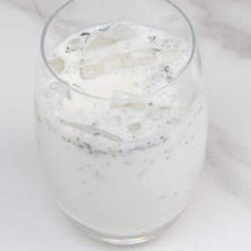 A glass with ayran and ice cubes