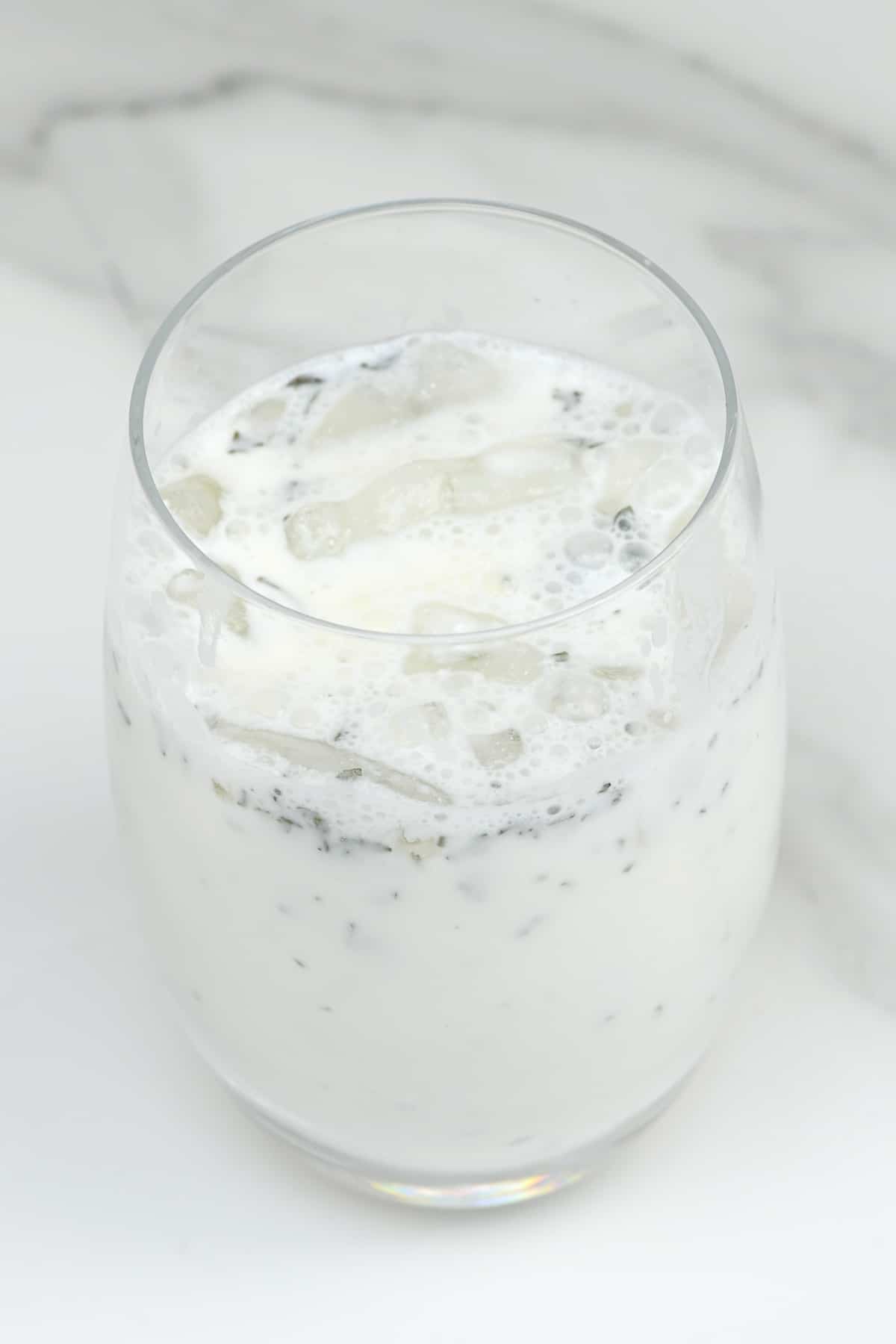 A glass with ayran and ice cubes