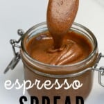 A spoonful with coffee peanut butter dripping in a jar