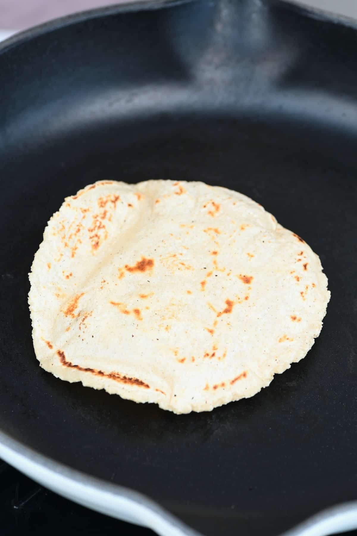 A puffed tortilla in a pan