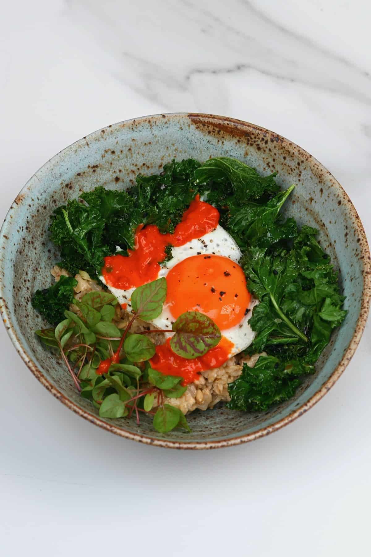 Oatmeal egg and kale in a bowl
