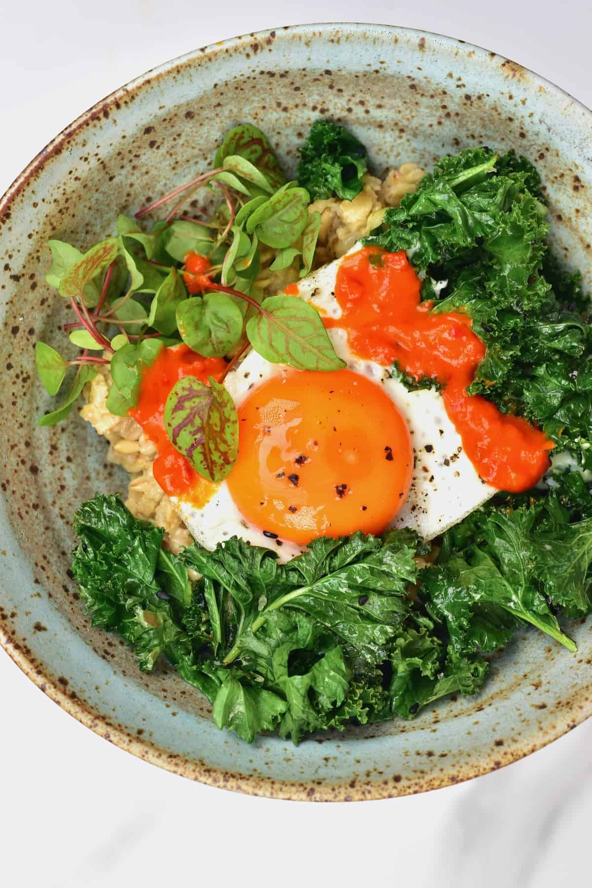 Oatmeal egg and kale in a bowl