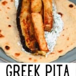 Greek pita bread topped with tzatziki eggplant and fries