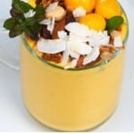 Mango lassi topped with fruit and nuts